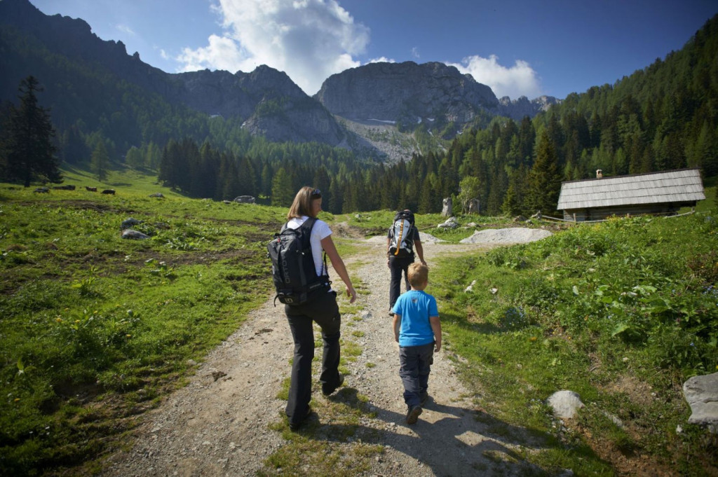 Family hiking along a trail in Logar Valley, Slovenia.