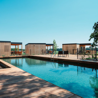 Outdoor swimming pool and modern wooden cabins at Wine Paradise Glavinič