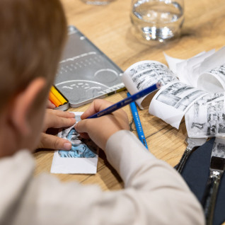 Child coloring a coloring book at Jasna Natur Resort