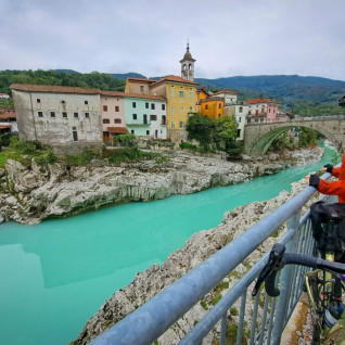 A cyclist looking at the bridge in Kanal ob Soči, Slovenia