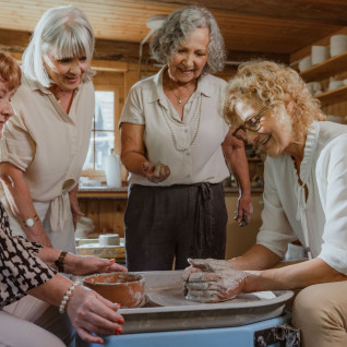 Women participating in a pottery workshop