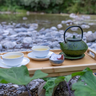 Welcome drink on a tray by the Idrijca river