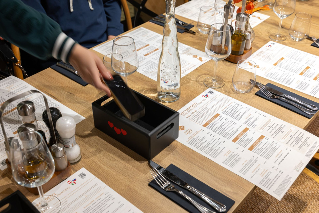 Phone-free dinner experience at Jasna Resort with guests placing their phones in a house of silence in Kranjska Gora, Slovenia