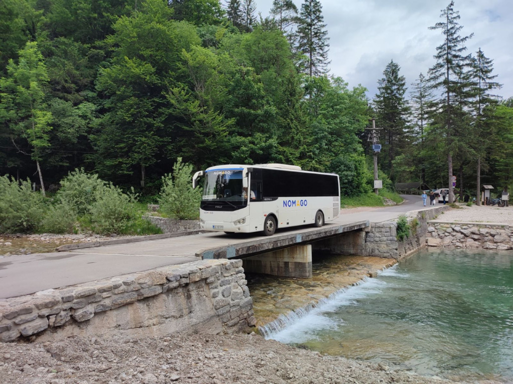 Free shuttle bus by the Idrijca River in Idrija, Slovenia, providing access to popular natural swimming spots without the need to travel by car.